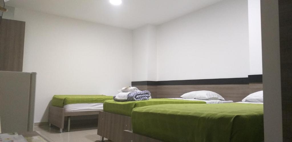 Postel nebo postele na pokoji v ubytování Hotel Ibague Plaza