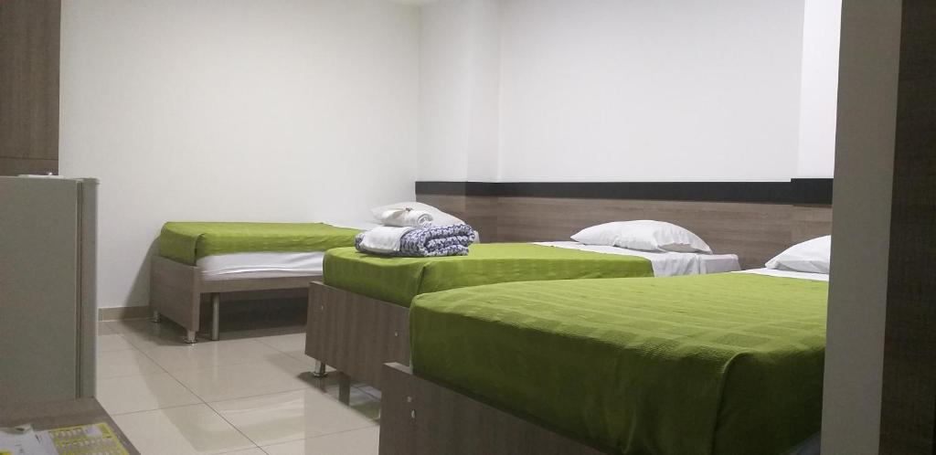 Postel nebo postele na pokoji v ubytování Hotel Ibague Plaza
