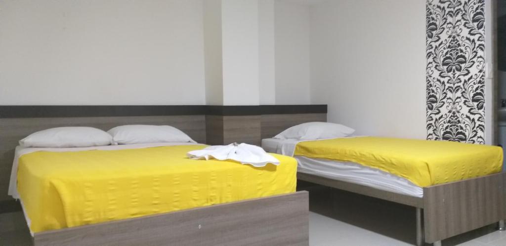 Postel nebo postele na pokoji v ubytování Hotel Ibague Plaza