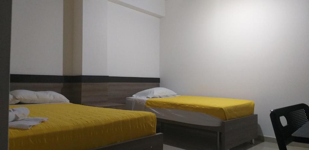 Postel nebo postele na pokoji v ubytování Hotel Ibague Plaza