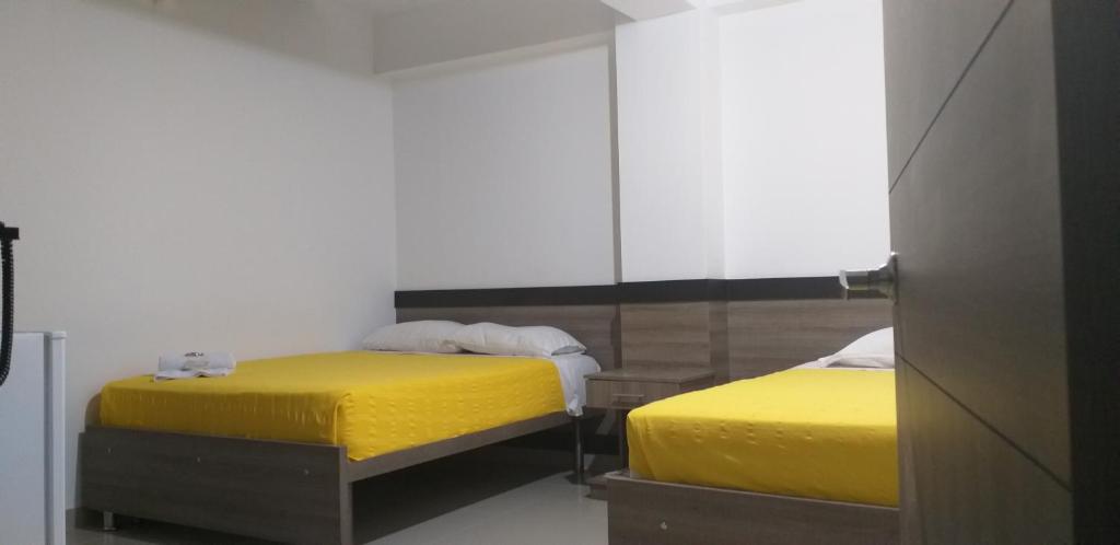 Postel nebo postele na pokoji v ubytování Hotel Ibague Plaza