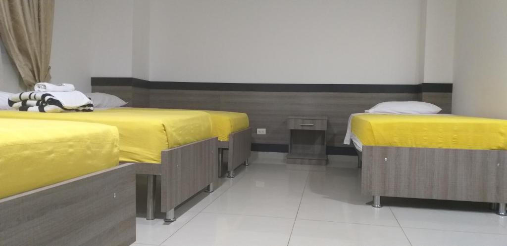 Postel nebo postele na pokoji v ubytování Hotel Ibague Plaza