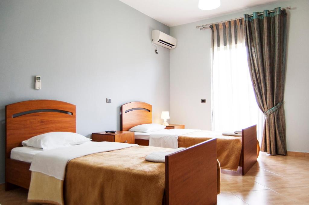 Postel nebo postele na pokoji v ubytování Dhima Hotel