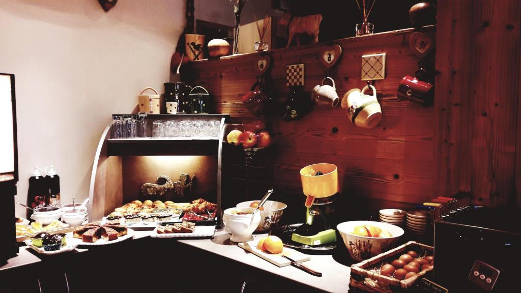 a kitchen with a table with food on it at Auberge du Manoir in Chamonix