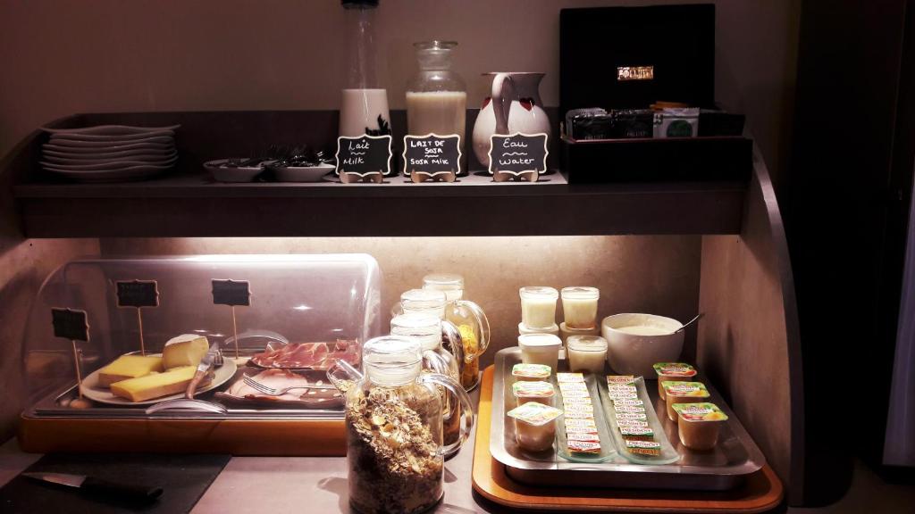 a refrigerator filled with lots of different types of food at Auberge du Manoir in Chamonix