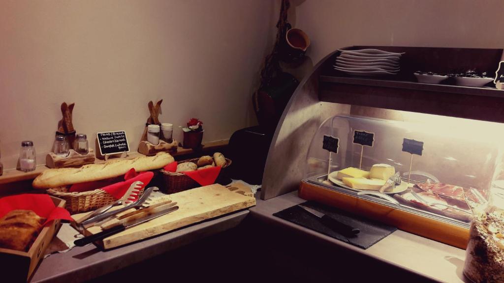 a kitchen with a counter with some food on it at Auberge du Manoir in Chamonix