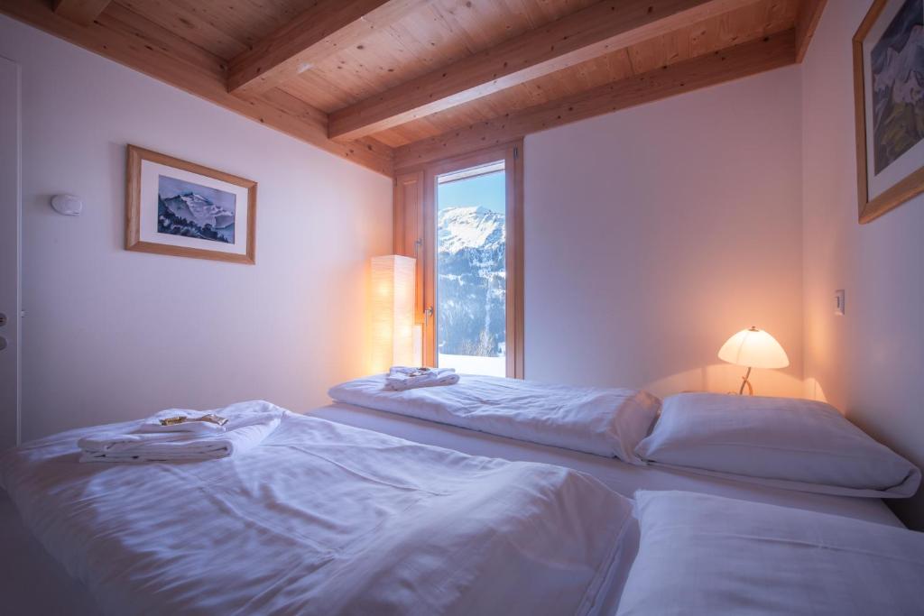 Postel nebo postele na pokoji v ubytování Chalet Roossi 3