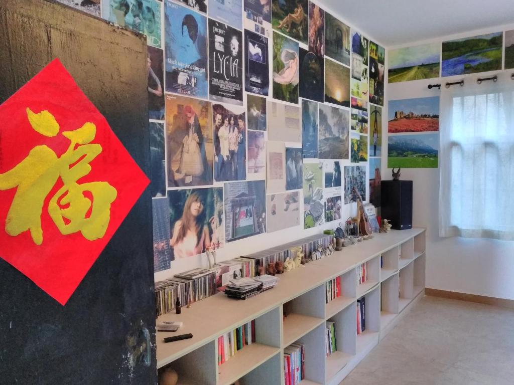 a room with bookshelves and a wall with pictures at Yuanyang Flower and Horse Inn in Yuanyang