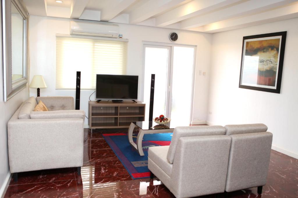 TV a/nebo společenská místnost v ubytování Centtro Residences
