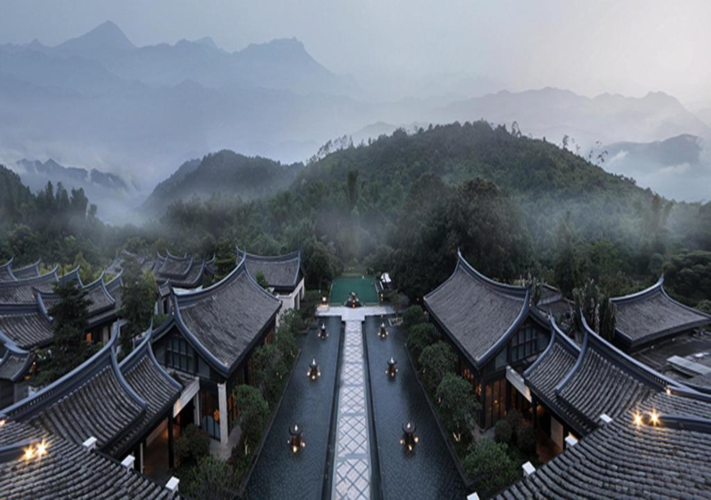 an aerial view of a building with mountains in the background at Elite Spring Villas in Anxi