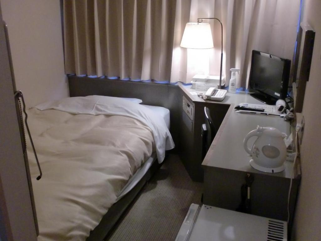 Postel nebo postele na pokoji v ubytování Tsuyama Central Hotel Annex