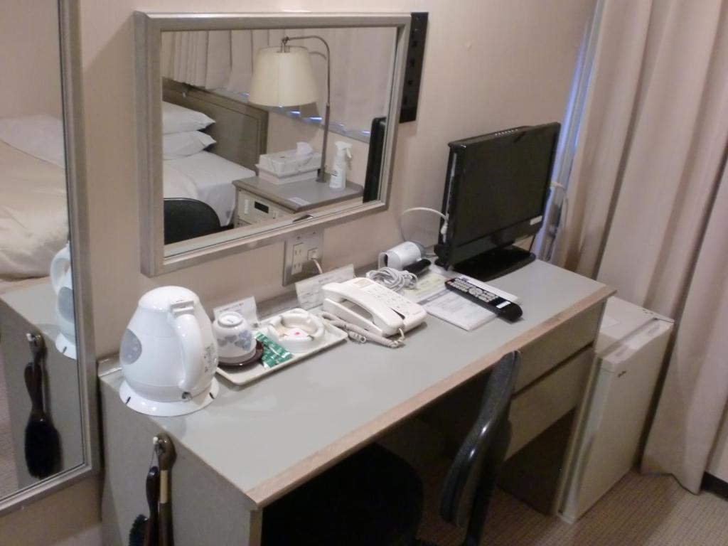 Postel nebo postele na pokoji v ubytování Tsuyama Central Hotel Annex