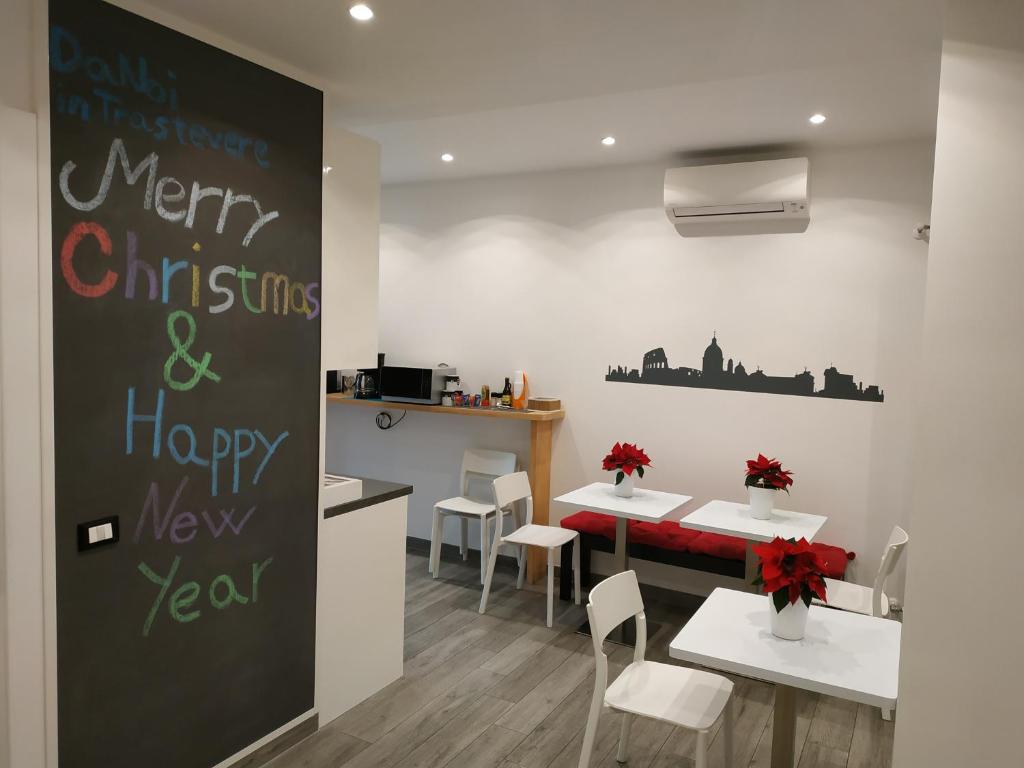 a dining room with a merry christmas and a happy new year sign at DaNoi in Trastevere in Rome