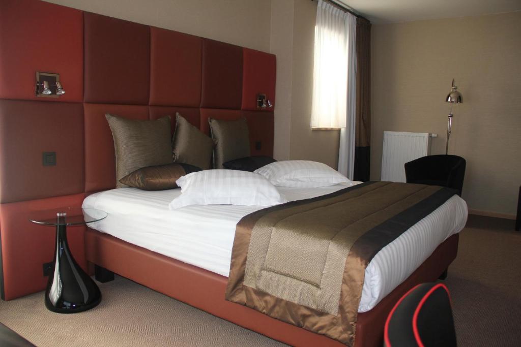 Postel nebo postele na pokoji v ubytování Hotel La Roseraie