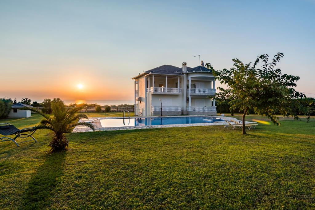 a large house with a swimming pool in a yard at Olympos Sunset Residence - Mountain and Sea View in Litochoro