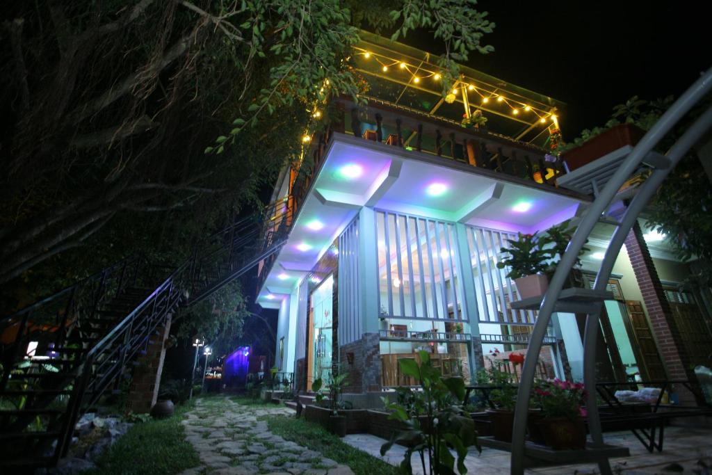 a building with lights on it at night at Ngoc's Garden House in Phong Nha