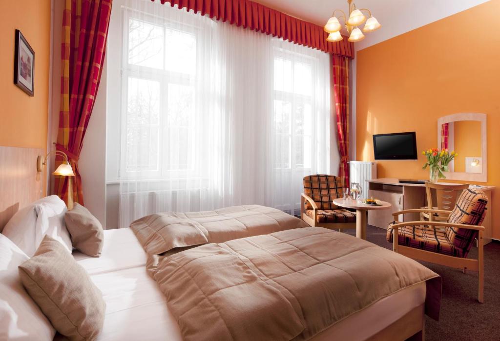 Postel nebo postele na pokoji v ubytování Hotel Metropol