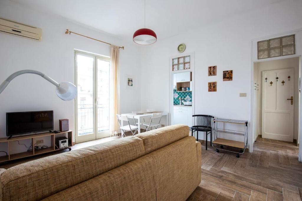 un soggiorno con divano e tavolo di Appartamento La Rosa Pantesca a Palermo