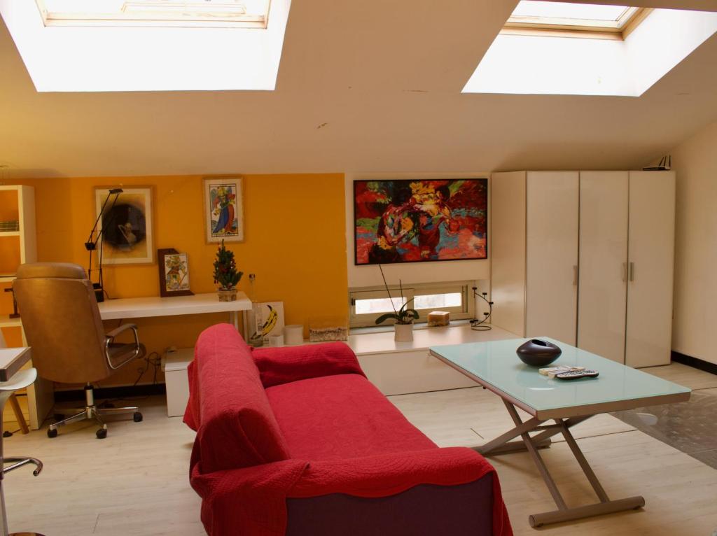 a living room with a red couch and a table at design loft in Cava deʼ Tirreni