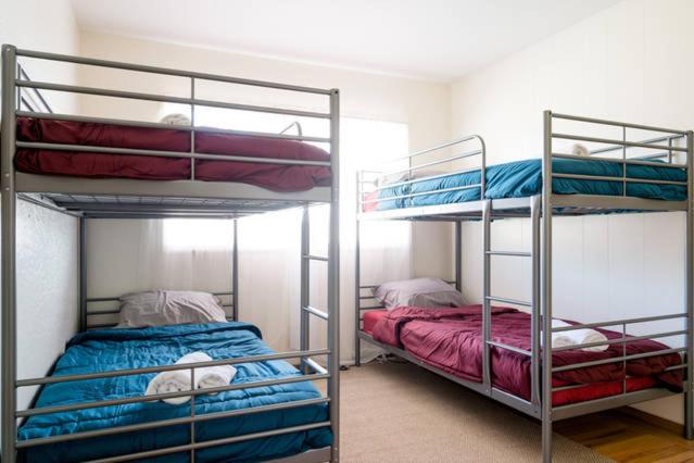 two bunk beds in a room with two beds at Hostel Style Shared Room in Daly City
