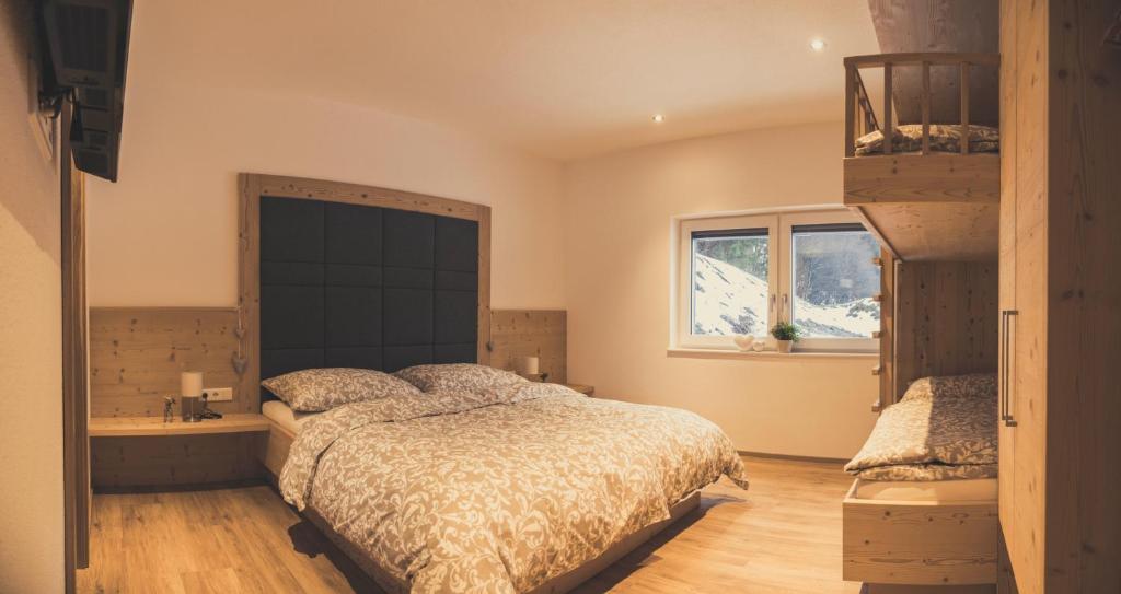 a bedroom with a large bed and a window at Haus Schlager "dasAppartement" in Annaberg im Lammertal