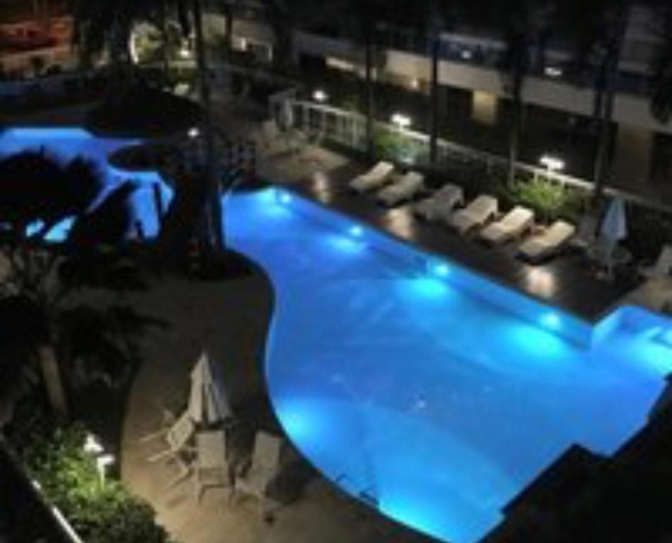 a large swimming pool in a building at night at Paraíso na Riviera São Lourenço - Laguna Home Resort in Riviera de São Lourenço