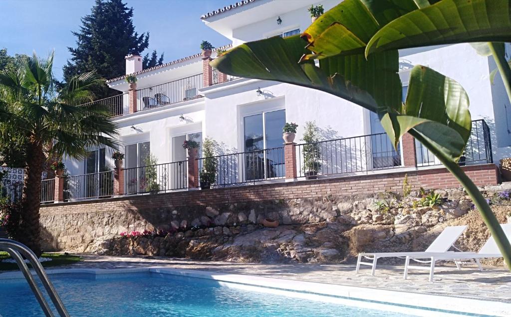 a house with a swimming pool in front of a house at Boutique X Pueblo, Benalmádena in Benalmádena