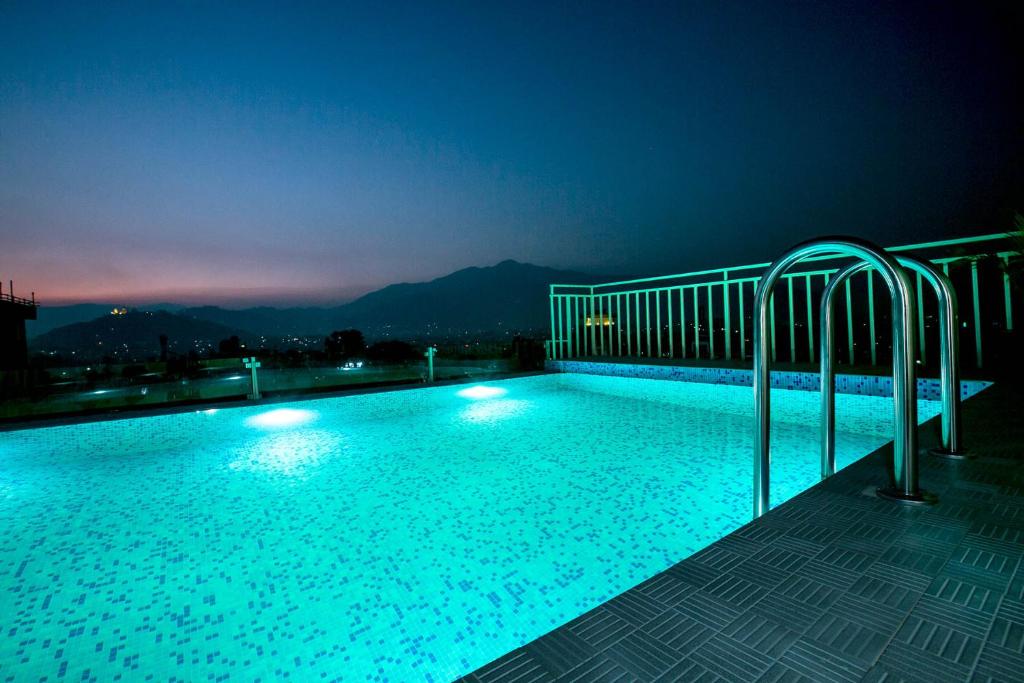 a swimming pool at night with the lights on at Beautiful Kathmandu Hotel in Kathmandu