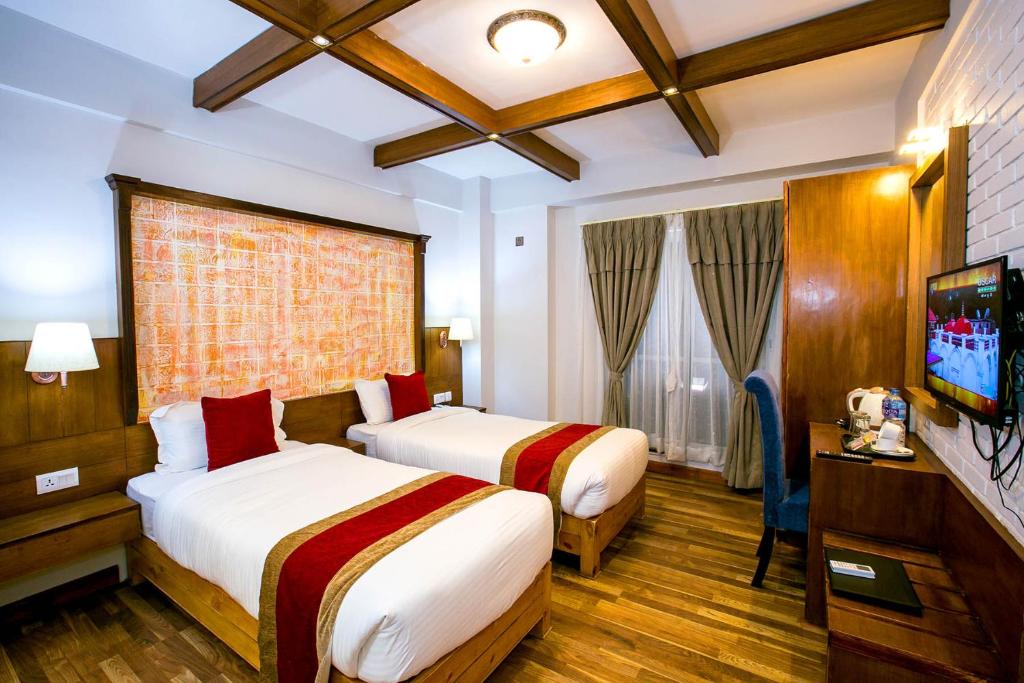 Postel nebo postele na pokoji v ubytování Beautiful Kathmandu Hotel