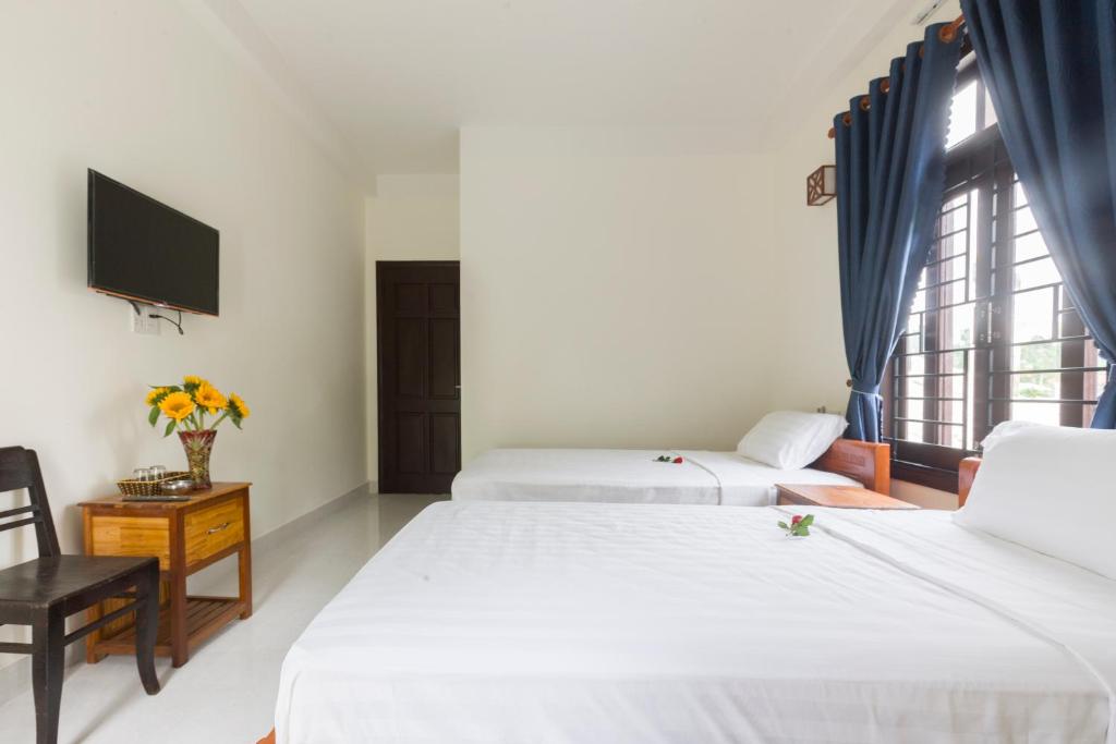 Postel nebo postele na pokoji v ubytování New Destination Hoi An