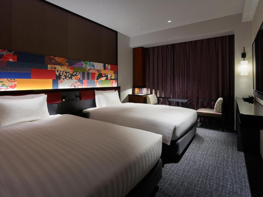 Postel nebo postele na pokoji v ubytování Mitsui Garden Hotel Kanazawa