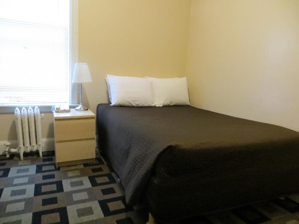 a small bedroom with a bed and a window at Hotel North Beach in San Francisco