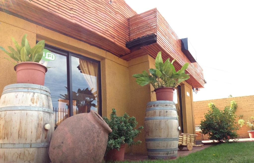 a building with two large barrels in front of it at Economy Hostel Tierra Noble in Santa Cruz