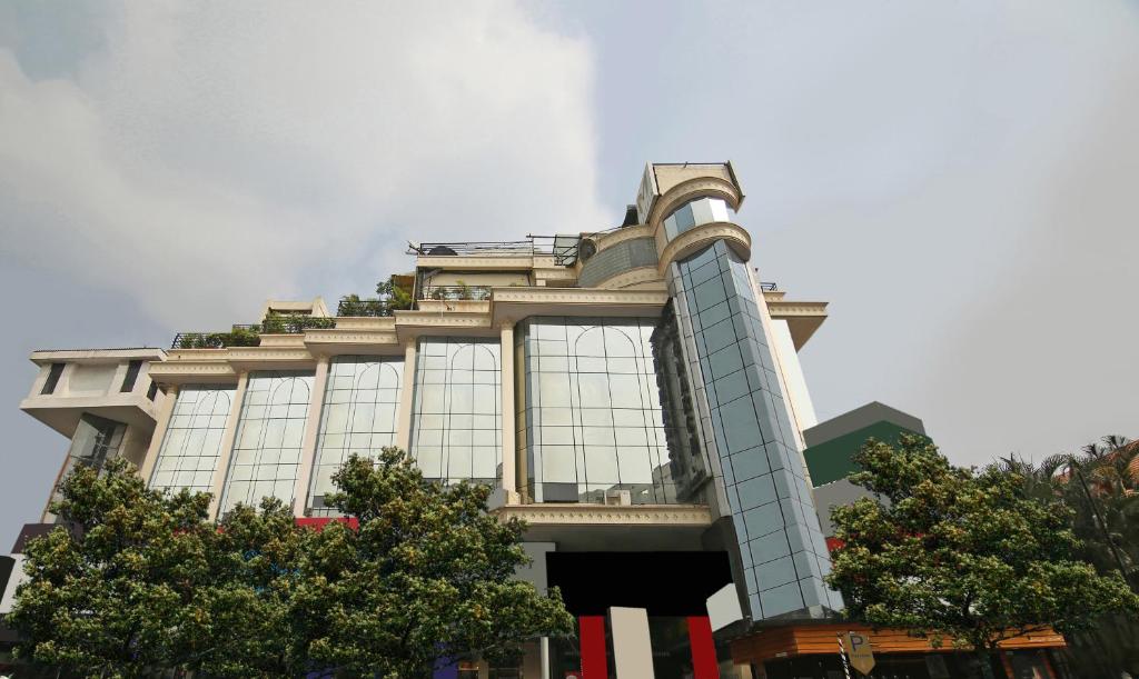 a building with trees in front of it at Monarch Brigade Road in Bangalore