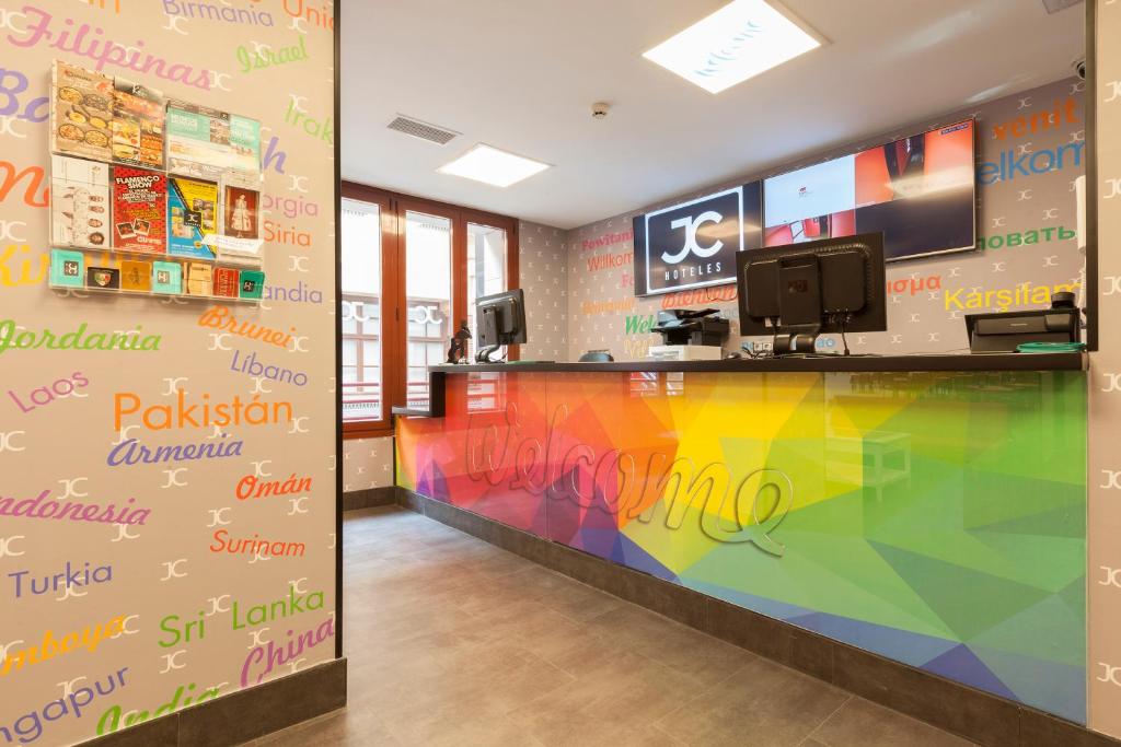 a lobby with a colorful wall in a store at Jc Rooms Jardines in Madrid