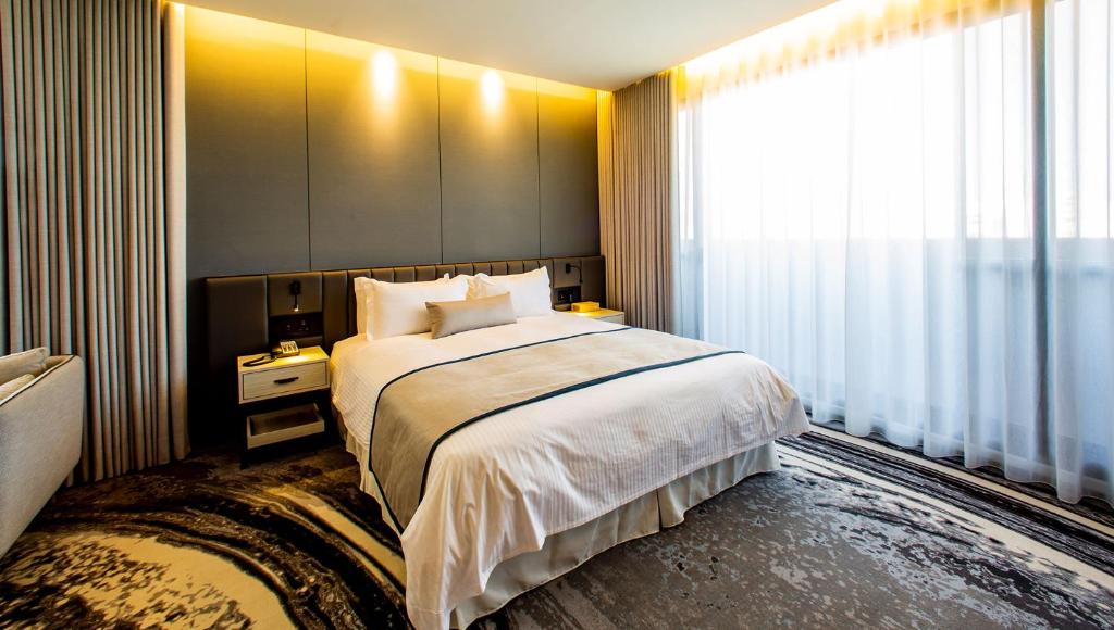 Postel nebo postele na pokoji v ubytování JSL hotel