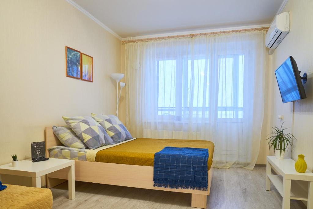 a small bedroom with a bed and a window at "GOOD NIGHT" on Ovrazhniy 17 in Tomsk