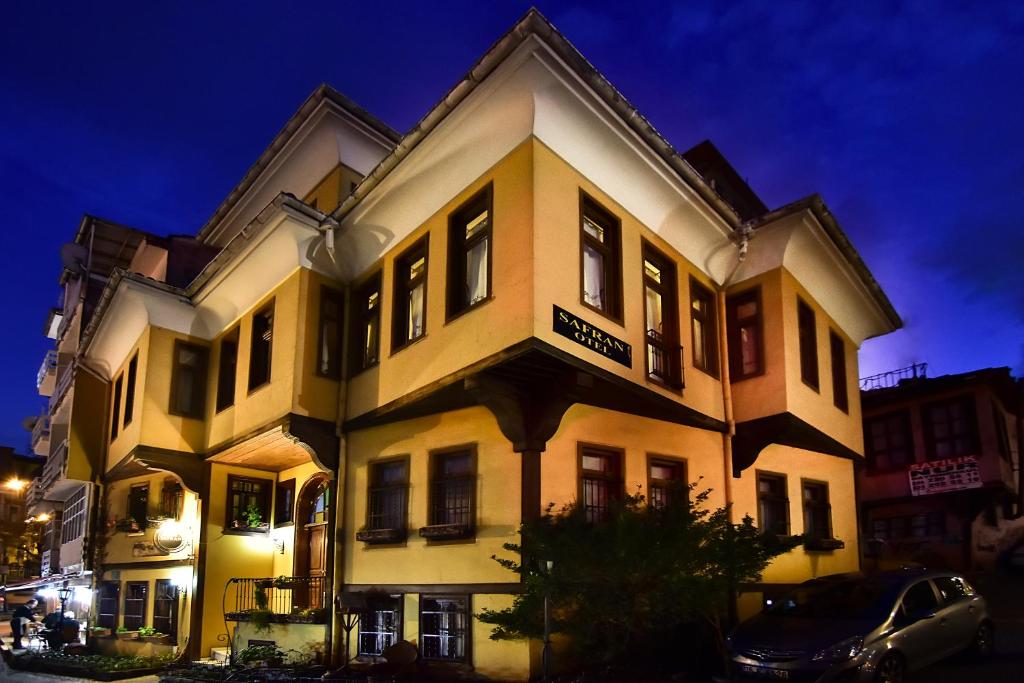 a large building with a sign on it at night at Safran Hotel in Bursa