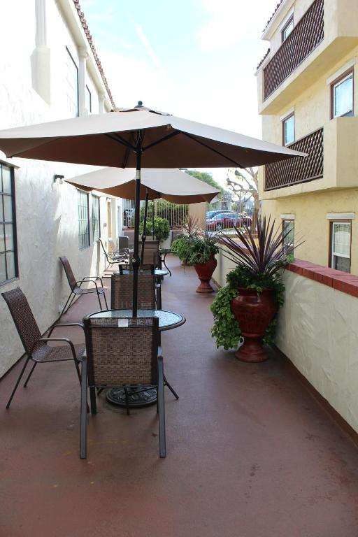 a patio with tables and chairs and an umbrella at Old Town Western Inn in San Diego