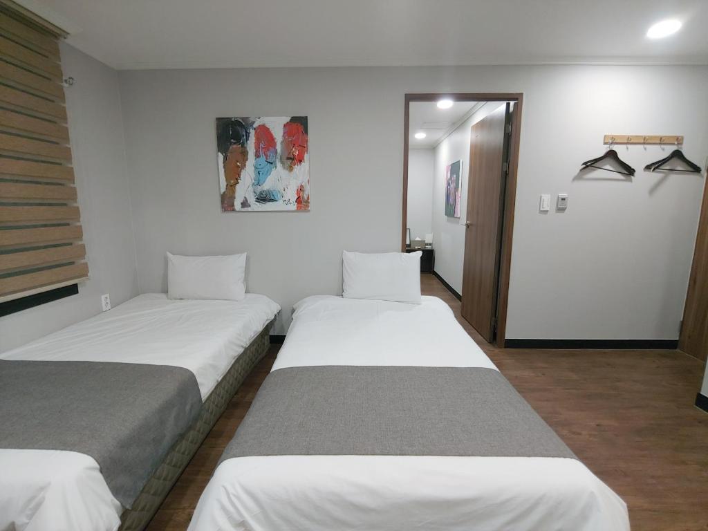 Postel nebo postele na pokoji v ubytování Hotel Tong Yeondong Jeju