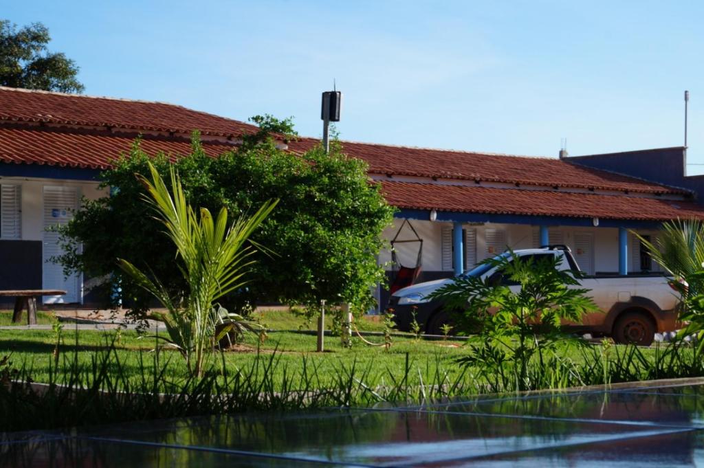 a house with a car parked in front of it at Pousada Aconchego in Mateiros