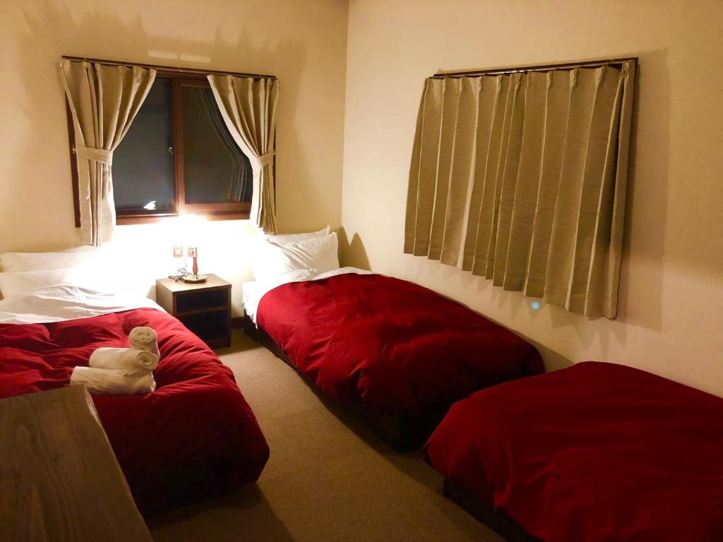 Postel nebo postele na pokoji v ubytování The Guest House Japan Hakuba
