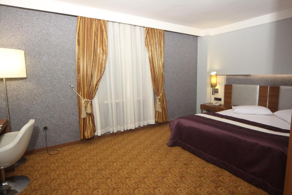 A bed or beds in a room at Suhan Cappadocia Hotel & Spa