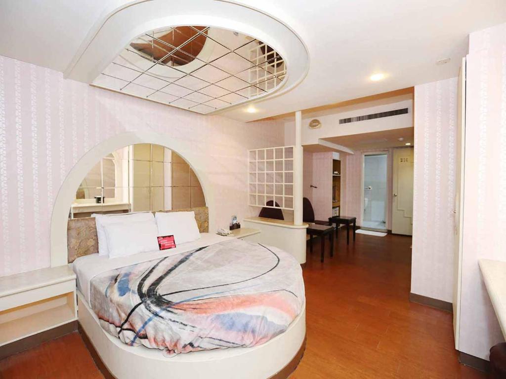 Postel nebo postele na pokoji v ubytování Midi Motel Tainan Branch
