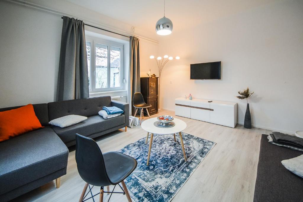 - un salon avec un canapé et une table dans l'établissement Kavon Apartments, à Ljubljana