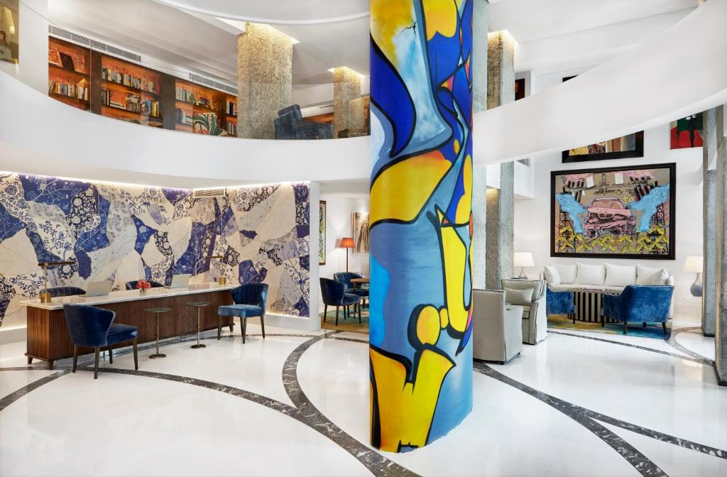 a lobby with a large colorful vase in the middle at The Merchant House in Manama