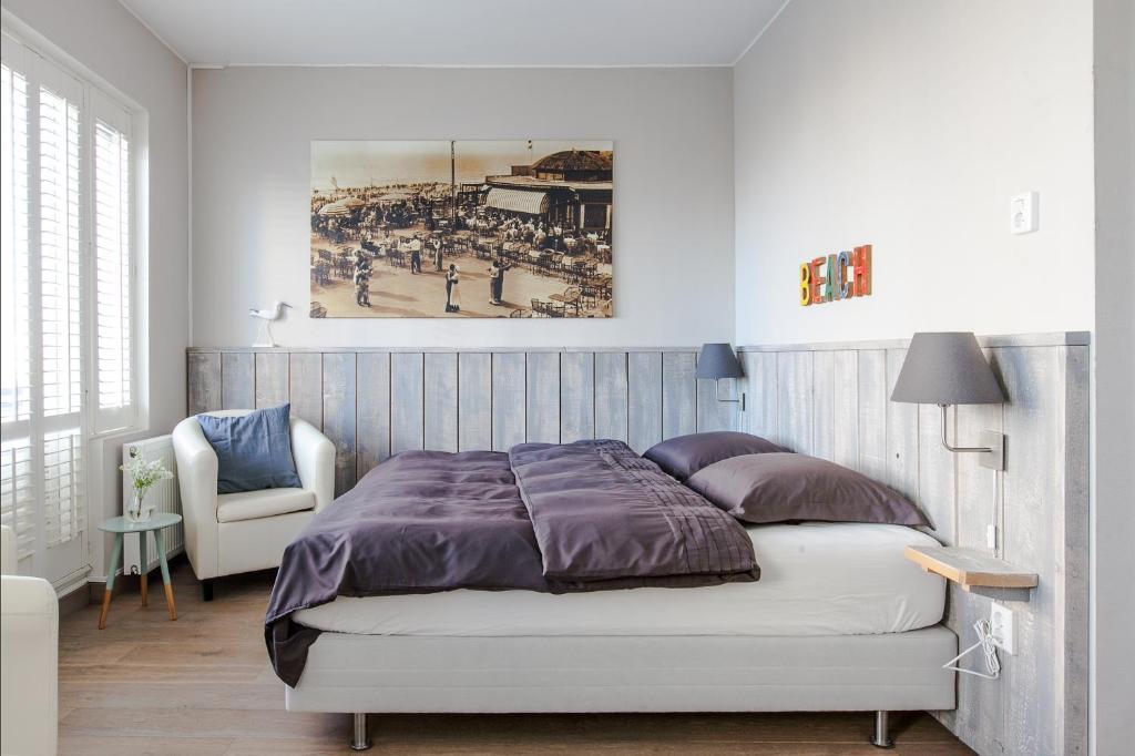 een slaapkamer met een bed en een foto van een honkbalwedstrijd bij Zeehuis Zandvoort in Zandvoort