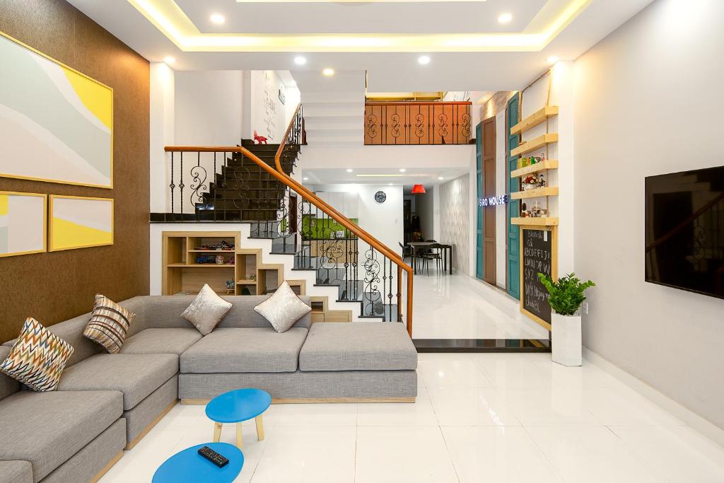 a living room with a couch and a staircase at Siro House Da Nang Homestay in Da Nang