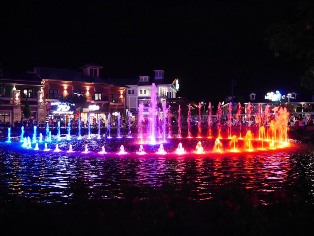 a fountain in the water with colorful lights at Americana Inn a Travelodge by Wyndham in Pigeon Forge