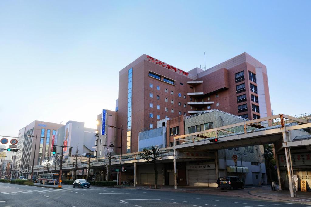 a city street with tall buildings and a bridge at Kurume Washington Hotel Plaza in Kurume